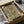 Framed abstract print featuring a contemplative arrangement of rectangles in gold, gray, white, and black with structured Bauhaus composition.