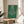 Minimalist art print of a stylized chandelier rendered in forest green, cream, and navy blue in the Bauhaus tradition, displayed as a framed wall artwork.