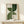 Contemporary wall art print with olive and sage green arched shapes on beige, displaying serene japandi-inspired geometric design in a simple frame.