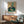 Abstract expressionist artwork exploring psychological depth through the image of a man and interior fixture, dominated by gray and orange tones.