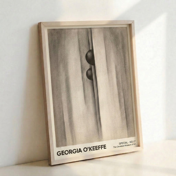 Framed abstract artwork depicting fluid fabric folds and rounded form in cream and charcoal, with a mysterious, meditative quality.