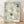 Abstract flower painting with layered cream and white petals surrounding a soft teal stamen, creating an intimate and sensual botanical composition in a minimalist modern style.