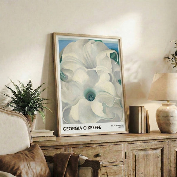 Soft, dreamlike depiction of flower petals in cream, pale blue, and gray tones arranged around a teal stamen, capturing the serene essence of botanical minimalism.