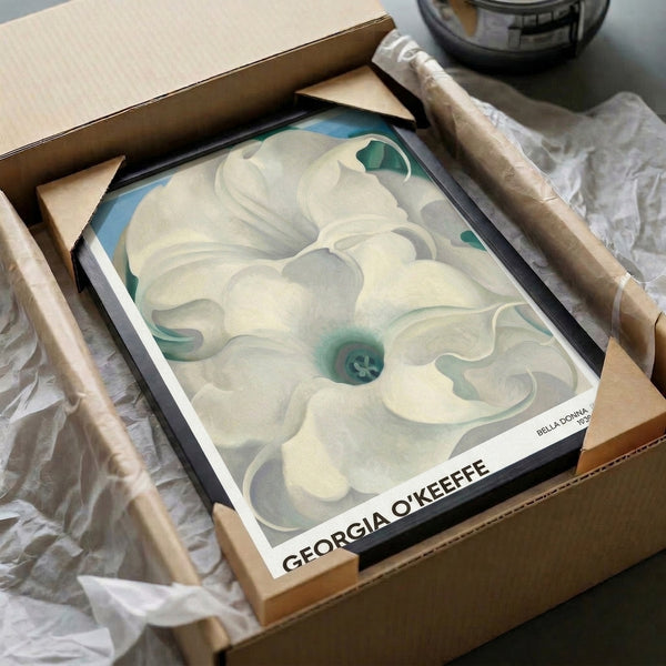 Framed art print showcasing an intimate close-up of flower petals in soft cream, gray, and pale blue surrounding a warm teal core in a peaceful, minimalist composition.