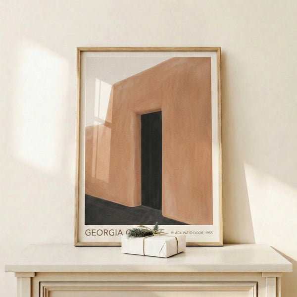 Contemporary wall art print showcasing a stark black architectural door form with serene earth tones of terracotta and cream.