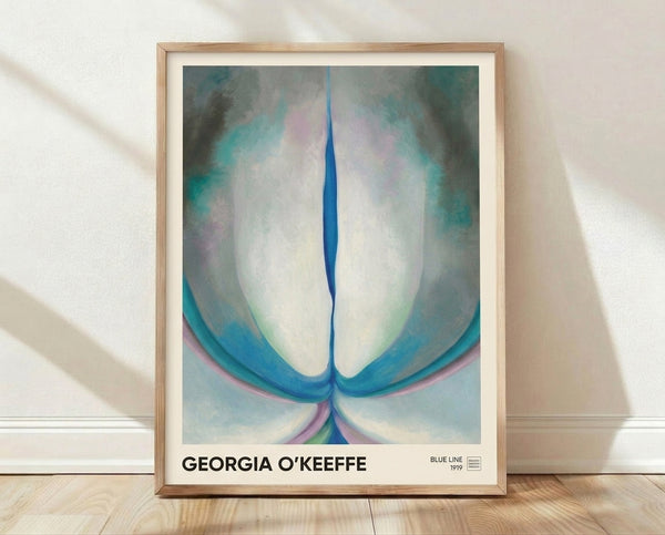 Abstract floral art print in soft cream and pale blue tones, featuring flowing curved petals in a minimalist composition by Georgia O'Keeffe, framed on a wall.