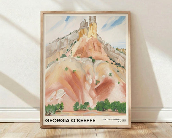Georgia O'Keeffe's Cliff Chimneys framed poster displays a contemplative landscape of towering rock formations in soft terracotta, cream, and sage green tones with impressionistic brushwork.