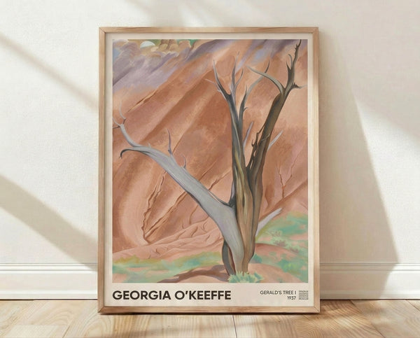 Framed impressionist landscape poster featuring a solitary desert tree rendered in terracotta, ochre, and sage green tones with sculptural, austere forms against mauve and cream mountains.