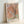 Impressionist desert tree painting in soft mauve, cream, and sage green, framed on wall as landscape art with austere, contemplative aesthetic.