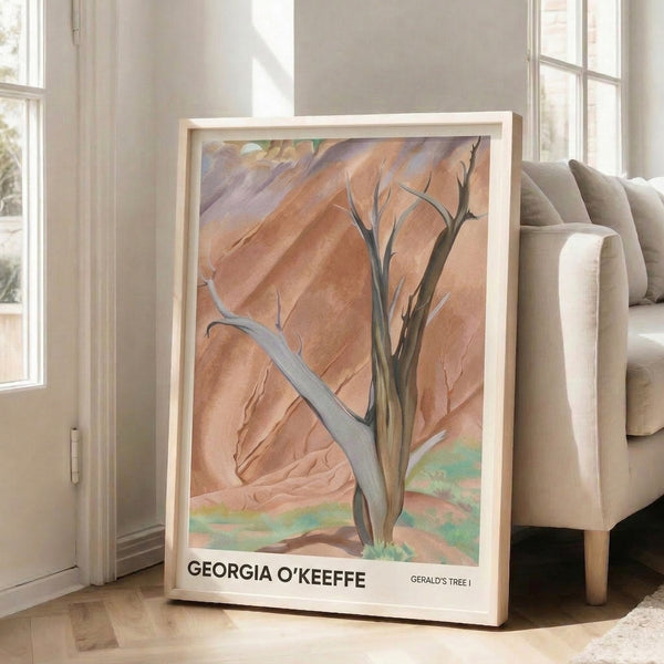 Watercolor-style framed poster showing a solitary tree in desert setting, rendered in warm terracotta and ochre with cool mauve and sage tones.
