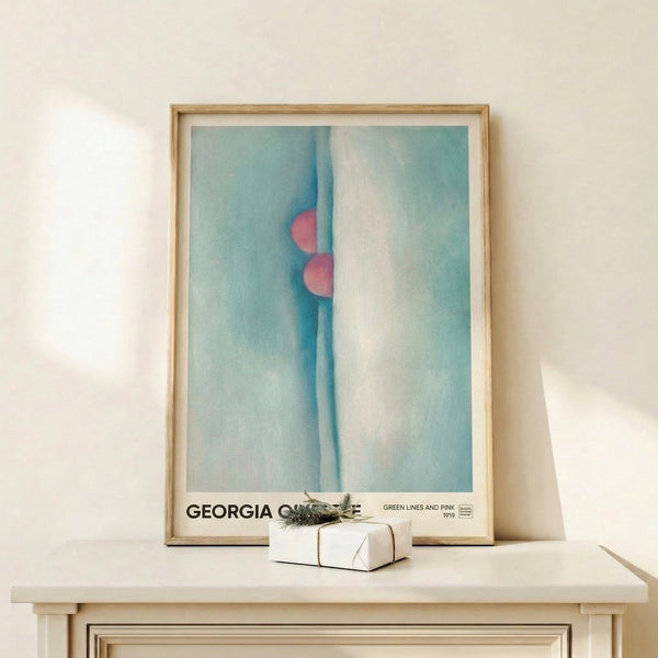 Abstract art print on a framed poster showing sinuous organic forms in teal and soft pink tones against a cream background, creating a meditative atmosphere.