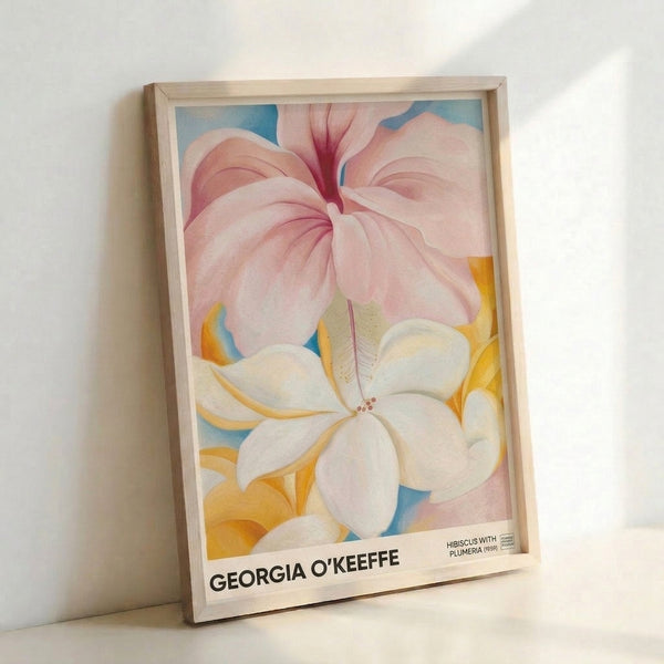 Elegant framed flower art print showcasing delicate plumeria and hibiscus petals in cream, pink, and pale yellow against a cool blue background in O'Keeffe's iconic abstracted style.