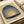 Minimalist abstract composition featuring a glowing dome in cream and pale yellow tones set against contemplative deep teal and slate blue gradients.