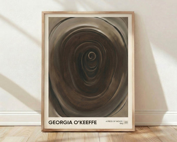 Abstract minimalist framed poster featuring a spiral wood grain composition in warm beige, taupe, and brown tones with charcoal accents, creating a meditative and organic aesthetic on a gallery wall.