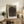 Abstract modern art print featuring fluid wood grain patterns and spiral composition in taupe, beige, and charcoal, creating a serene and contemplative visual experience on the wall.