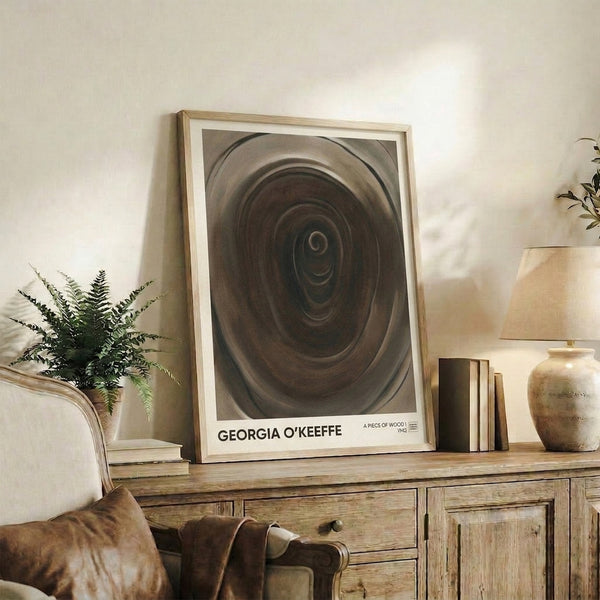 Abstract modern art print featuring fluid wood grain patterns and spiral composition in taupe, beige, and charcoal, creating a serene and contemplative visual experience on the wall.