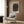 Minimalist gallery-style framed poster of organic wood textures rendered as spiral forms in harmonious earth tones of cream, brown, and charcoal for meditative home decor.