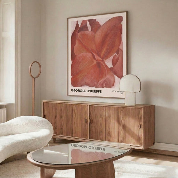 Framed botanical masterpiece depicting luxurious red and cream canna petals in soft, introspective tones on a gallery wall.