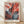 Abstract framed poster of a sensual red maple leaf rendered in deep burgundy and crimson tones against soft cream and slate blue, evoking the contemplative mood of Georgia O'Keeffe's nature studies.