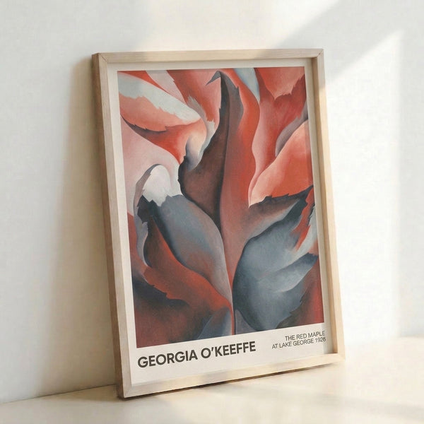 Framed wall art featuring an abstracted maple leaf in deep red and burgundy with cream and blue undertones, capturing the sensual, contemplative quality of O'Keeffe's iconic approach to nature.