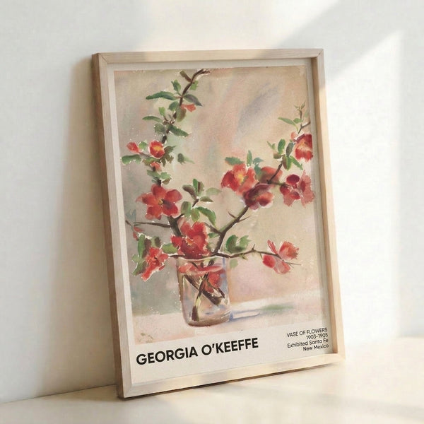Serene framed floral artwork with impressionist watercolor technique, depicting vibrant red blooms and brown-green stems arranged in an elegant cream vase.