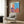 Stylized portrait poster in vibrant pop art colors with bold lines and flattened features, hung as contemporary home decor.