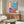 Framed modern art print of a pop art-style portrait with simplified facial forms and bright, eye-catching color blocking.