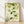 Watercolor painting of delicate ginkgo leaves and white blossoms on a soft cream background, rendered in sage and pale green tones with minimalist brushwork.