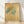 Japanese woodblock print of delicate ginkgo leaves in soft sage green and ochre tones on a cream background, evoking serene botanical study.