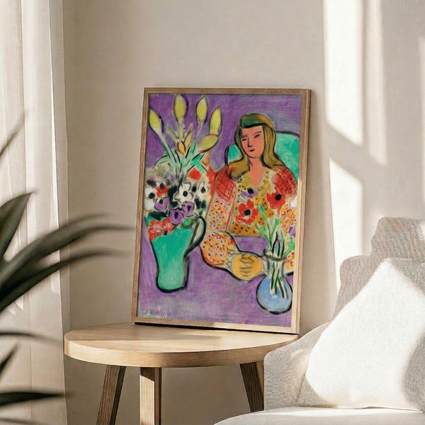 Framed wall art print displaying a portrait with delicate anemones in watercolor style against a saturated purple field.