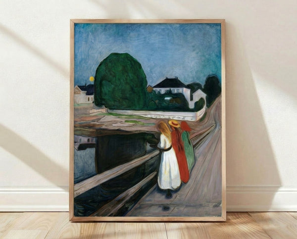 Framed art print of Edvard Munch's Girls On The Bridge, an Impressionist masterpiece featuring three figures in dark clothing standing on a pier overlooking water, rendered in moody blues, greens, and muted earth tones.