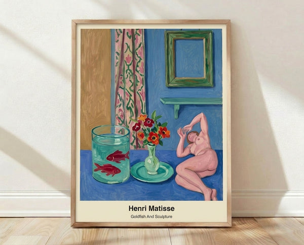 Abstract framed poster featuring a bright blue goldfish and sculptural form in coral, green, and ochre tones, playful modern cutout artwork inspired by Matisse.