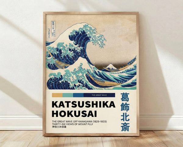 Framed Japanese woodblock print of a dramatic wave with a distant snow-capped mountain, rendered in navy blue, turquoise, and cream tones.