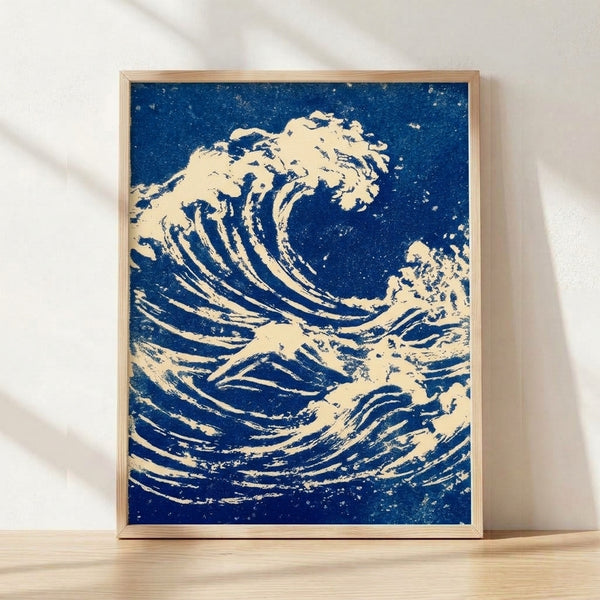 Hokusai's iconic woodblock print depicts a dramatic wave with white foam cresting over Mount Fuji, rendered in navy blue and cream tones with dynamic yet majestic energy.