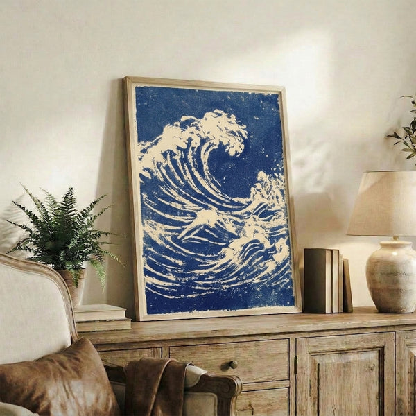 Classic Japanese woodblock artwork featuring a powerful ocean wave in deep indigo and white, with a serene snow-capped mountain visible in the background.
