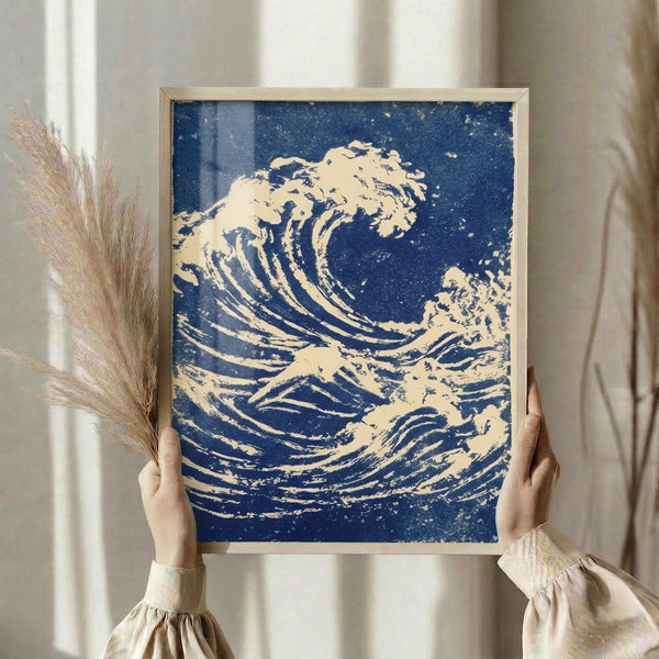 Framed vintage woodblock print showing a sweeping wave with white spray against navy blue waters, capturing both turbulent motion and peaceful grandeur.