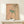 Wall art print featuring a graceful bird nestled among flowering branches with cream, charcoal, and sage green palette in authentic woodblock tradition.