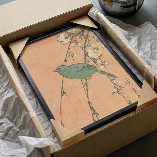 Framed art print of a contemplative bird among delicate blossoms and foliage, rendered in muted peach, sage green, and charcoal in Japanese woodblock style.
