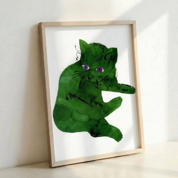 Contemporary pop art print showing a striking green feline portrait with flat color fields and bold outlines, mounted and framed for wall display.