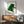 Pop art style cat portrait rendered in luminous green with flat graphic shapes and bold edges, presented as a framed wall art piece.