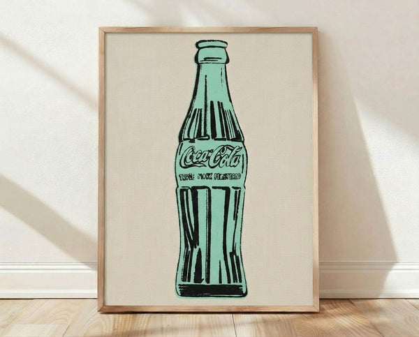 Framed pop art poster featuring a bold green Coca-Cola bottle against a contrasting background, iconic modern wall art in vibrant colors.