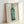 Framed art print showcasing a luminous green bottle in pop art style, bold and graphic modern wall decor with vibrant tonal palette.
