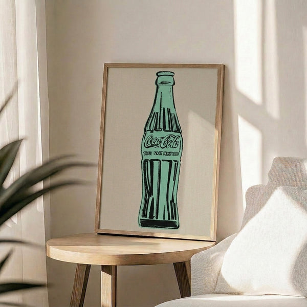 Green bottle pop art print in a frame, iconic contemporary wall art with simplified graphic forms and vibrant color palette.