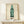Pop art poster with a simplified green Coca-Cola bottle silhouette in bold emerald tones, framed as a statement piece on consumer culture and mass production.