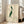 Japanese-inspired woodblock art depicting a graceful pelican with flowing lines in soft cream, dark green, and rust red hues, embodying zen aesthetic.