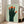 Thought-provoking Bauhaus print depicting a single hand with five faces woven throughout the fingers, rendered in earthy tones of sage, forest green, and burnt orange.