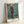 Modern art print of Cezanne's faceless harlequin figure, combining ochre, red, and cream tones in a solitary, contemplative composition.