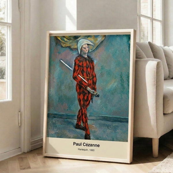 Wall art displaying Cezanne's melancholic harlequin study from 1880, featuring bold impressionist brushwork in ochre, red, and blue.