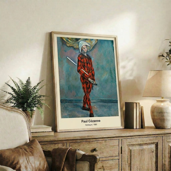 Cezanne's solitary harlequin figure rendered in warm and cool tones, capturing an introspective mood through impressionist painting technique.