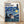 Whimsical framed poster featuring Totoro holding an umbrella beneath a starry night sky with swirling stars and a crescent moon, inspired by Van Gogh's Starry Night style with deep blue, yellow, and cream tones.